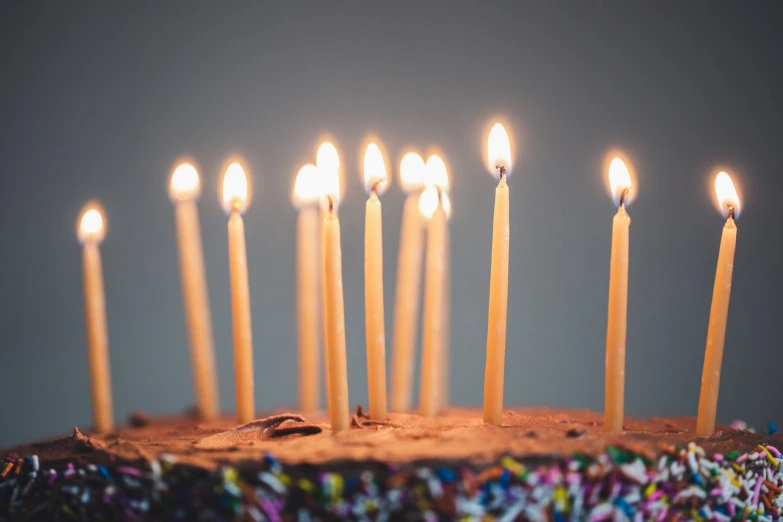 a cake has many candles sticking out of it