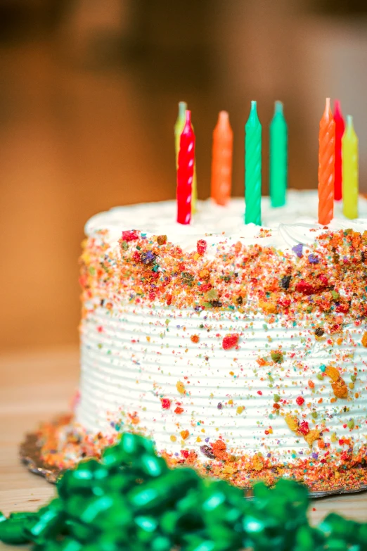 birthday cake with icing and decorations surrounded by confetti