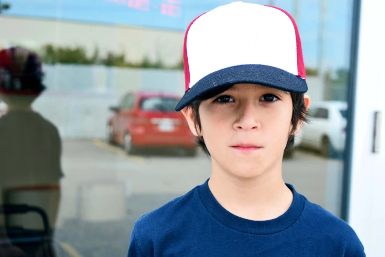 there is a man wearing a blue shirt and a red and white hat