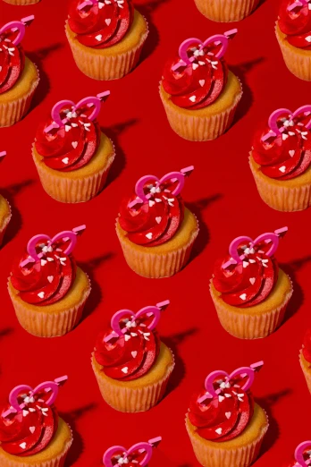 a group of cupcakes with bows and hearts