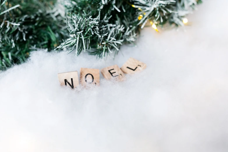 a close up of word spelled by cubes in the snow