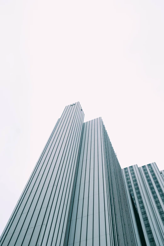 a very tall building standing under a cloudy sky