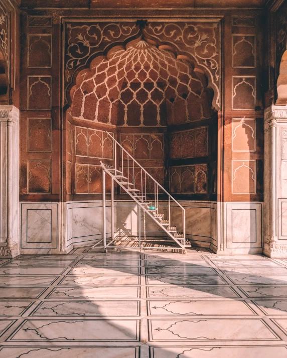 a room with white stone and a staircase leading up to it