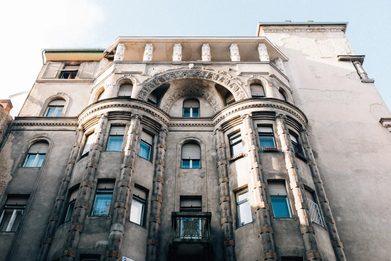 the front view of an old building with a sky background