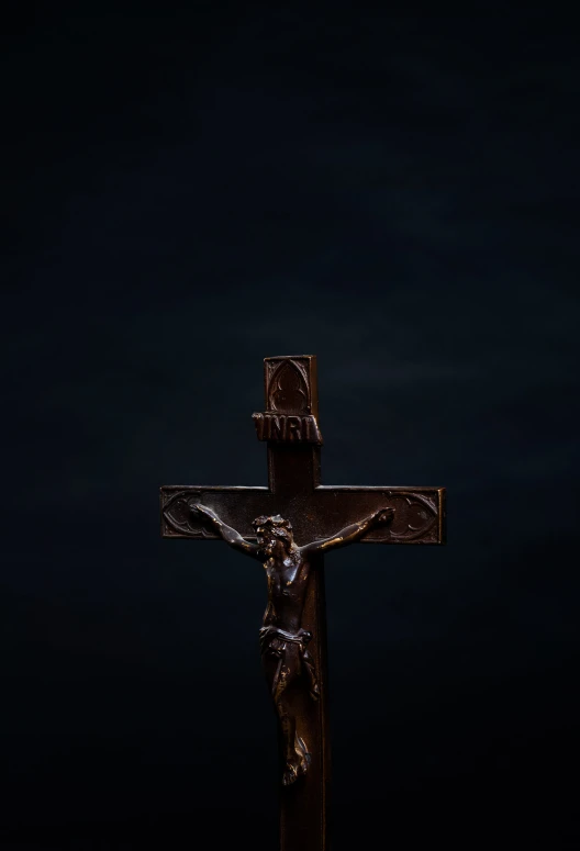 a wooden cross and jesus's crucifix are lit up