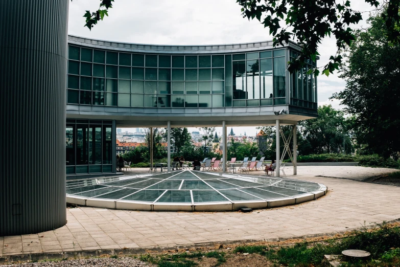 an empty circular building has many trees near it