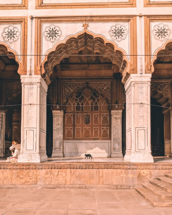 an intricately decorated building with a dog under it