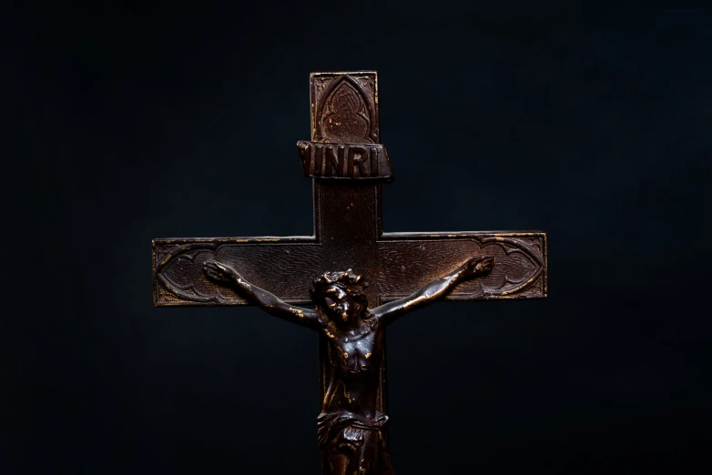 a close up view of a cross on black