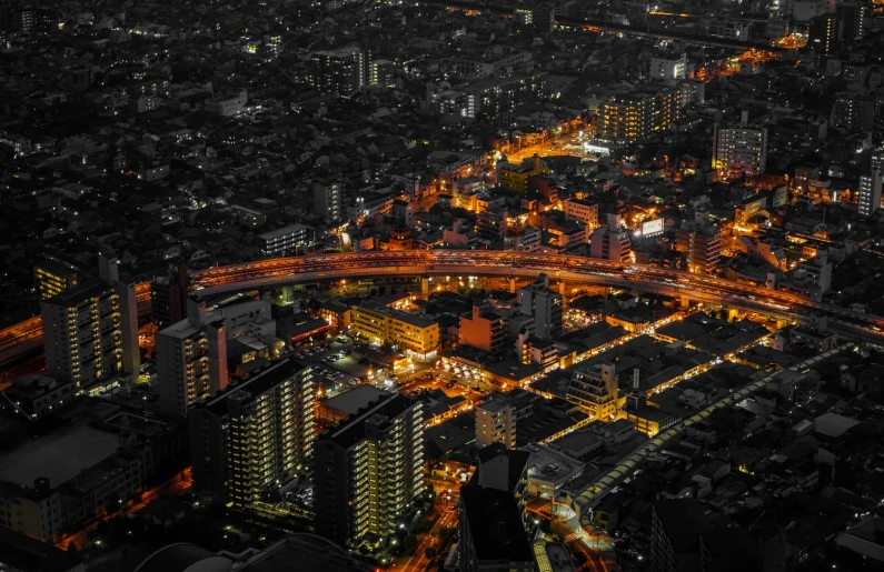 an aerial view of a city with many lights in the dark