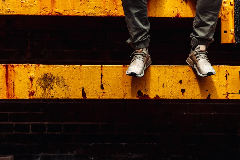 person standing in the middle of stairs with their shoes off