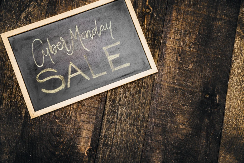 an old wooden table with a sign that reads happy birthday sale