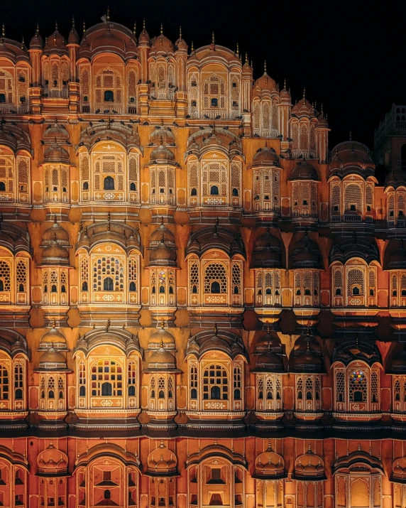 the facade of an illuminated building is in red glow
