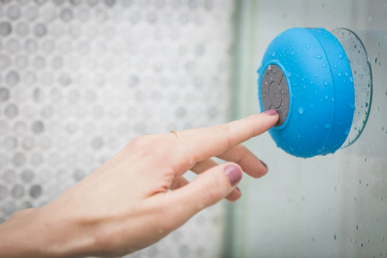 a person pressing on the on on a blue wall