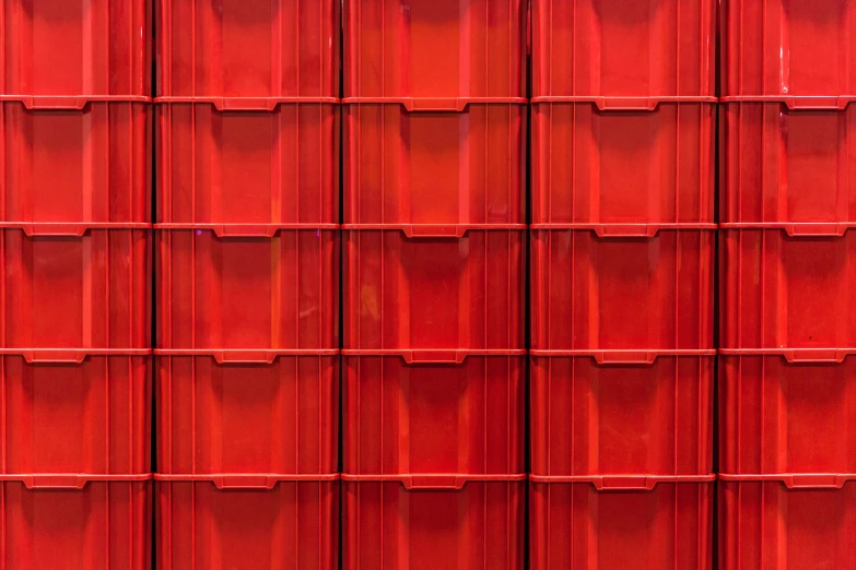 a large red metal storage unit next to a wall