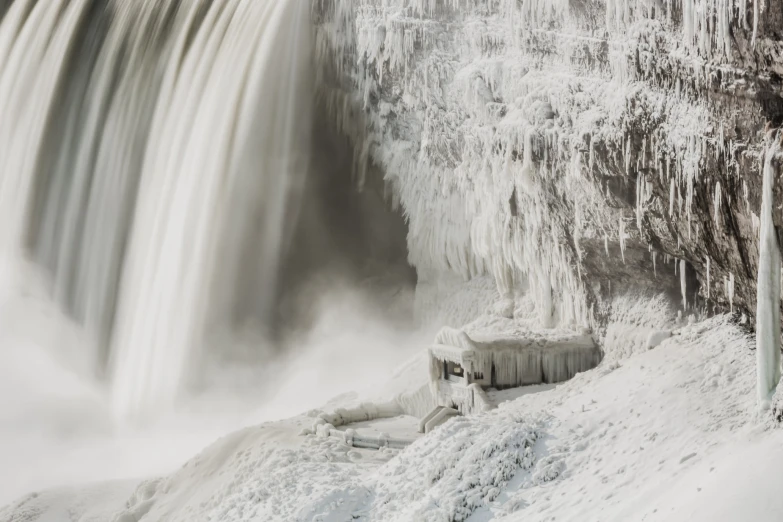 a waterfall with ice hanging off of the side