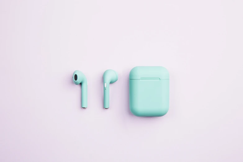 two light green air pods next to each other