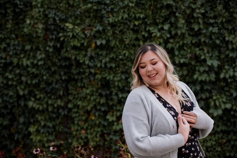 a woman in a floral dress and cardigan