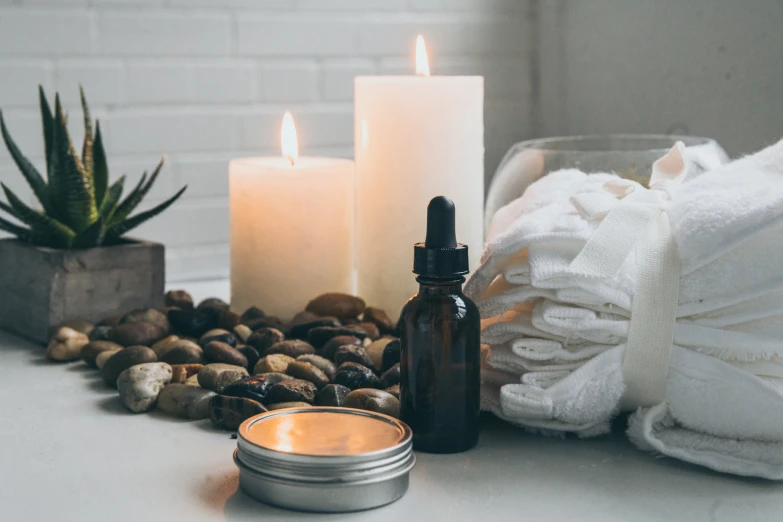 some kind of jar sitting on a table next to two candles