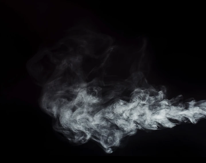 smoke is shown on the black surface with the dark background