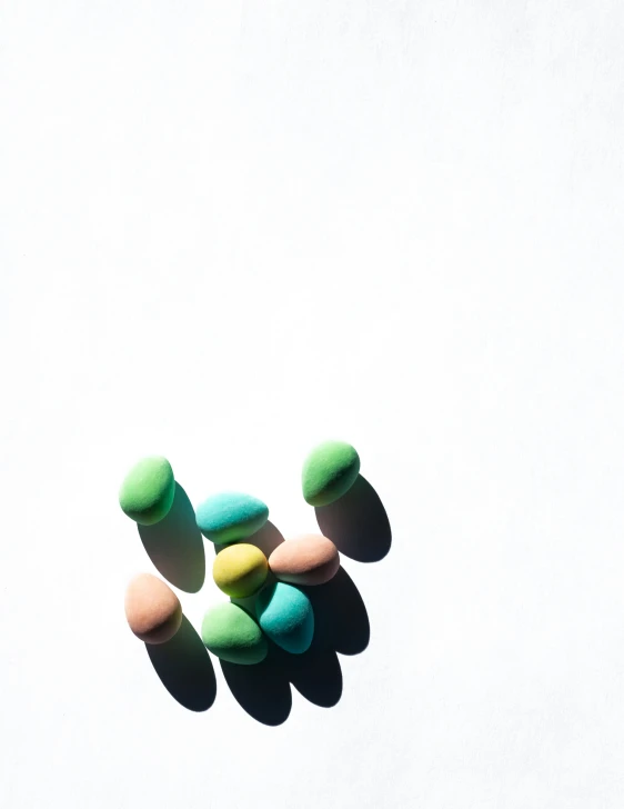 several colorful candies in a group against a white background