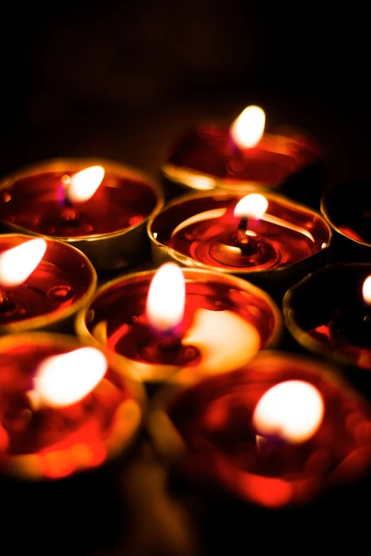 a group of lit candles that are sitting on a table