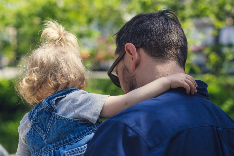 a man is carrying his child in the air