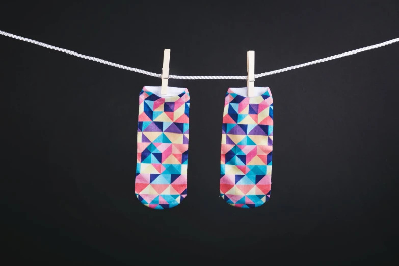 pair of rectangular patterned water shoes on clothes line