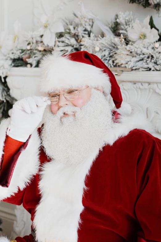 a santa clause looking in the camera with white decorations