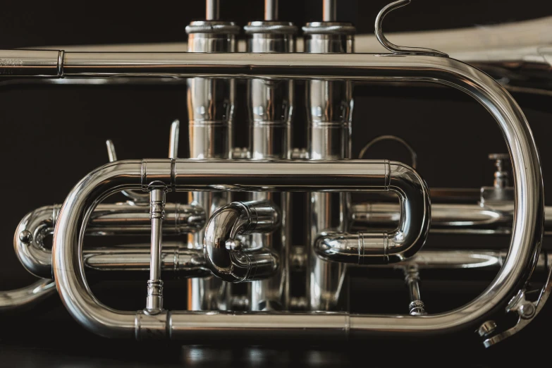 a silver - plated instrument with a black background