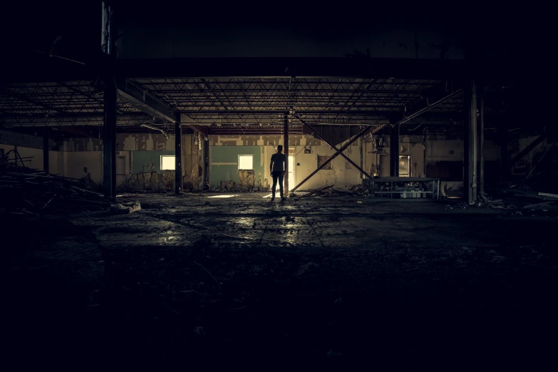 a woman in a darkened room standing alone