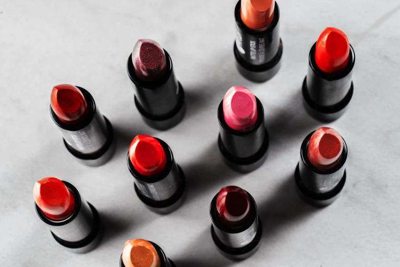 a group of nine lipsticks on a table