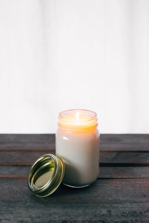 a candle is sitting on a table beside it