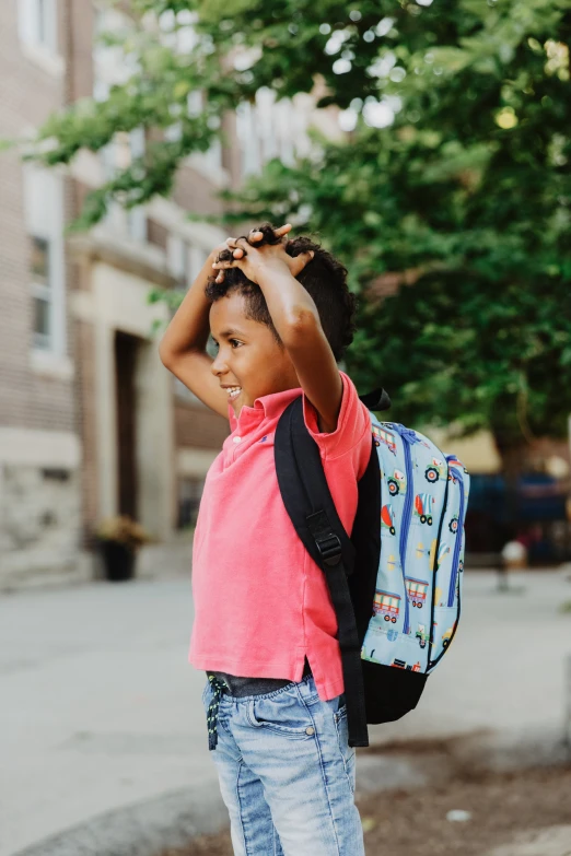 a  is standing outside with a backpack