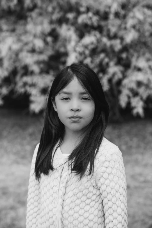 a girl wearing a sweater looking to the side