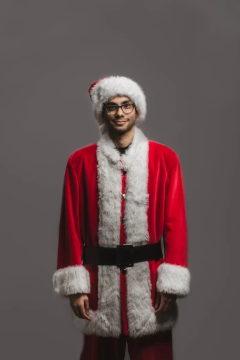 a man in santa claus clothing is posing for a pograph