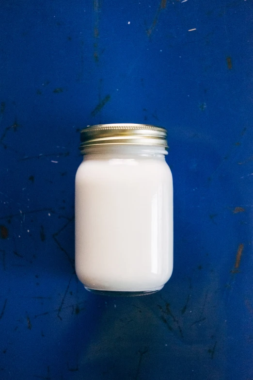 a bottle of milk sitting on top of a blue counter