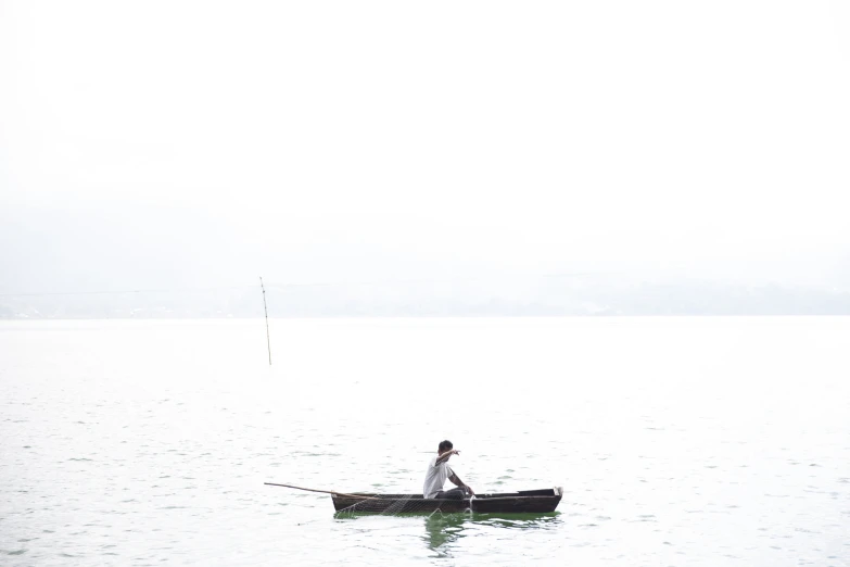 a man in a canoe is paddling on the water
