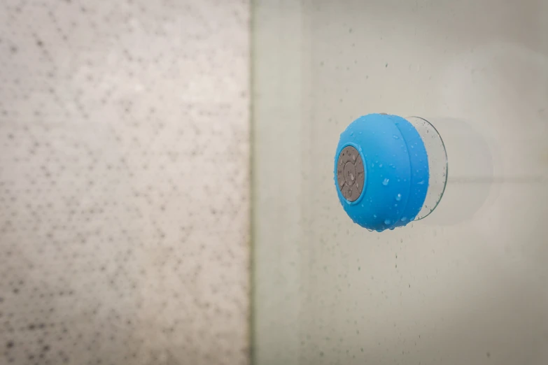 a close up of a blue object in a shower