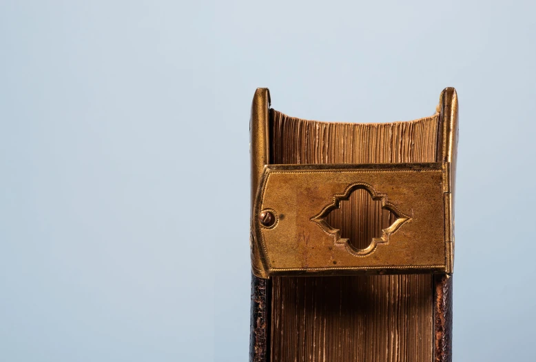 a tall chair with an intricate design sits in front of the sky