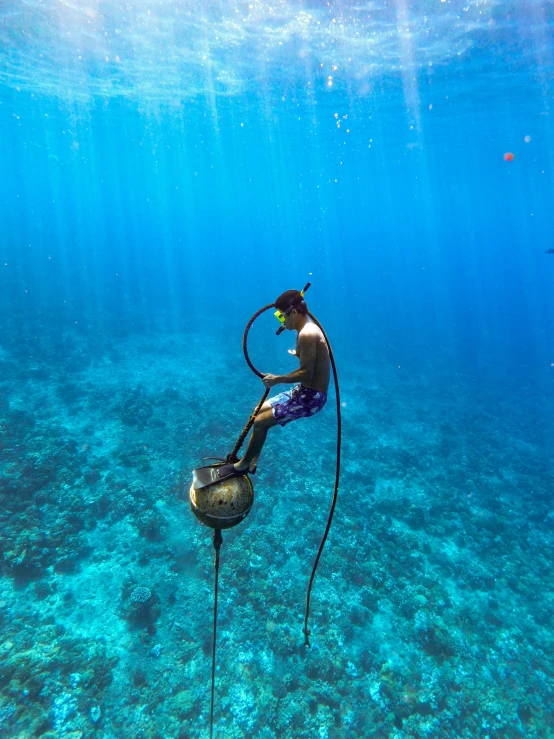 a man is working on a fishing rod with a helmet