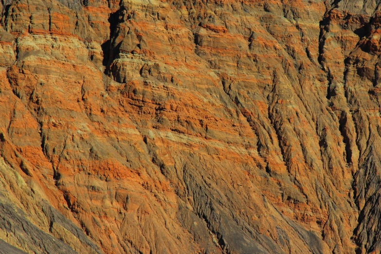 a high cliff line with red and yellow stripes