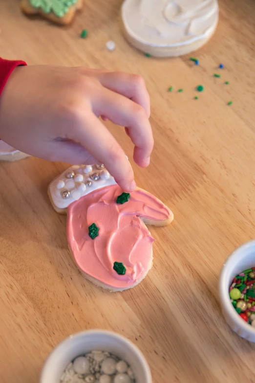 a child is decorating the decorated cookies and candies