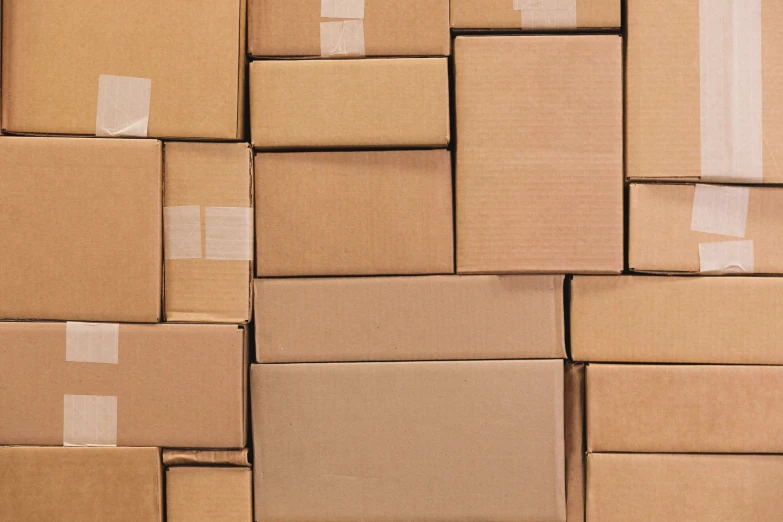 cardboard boxes stacked and sealed into an empty room