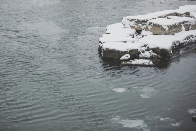 a man standing on a rock ledge in the water