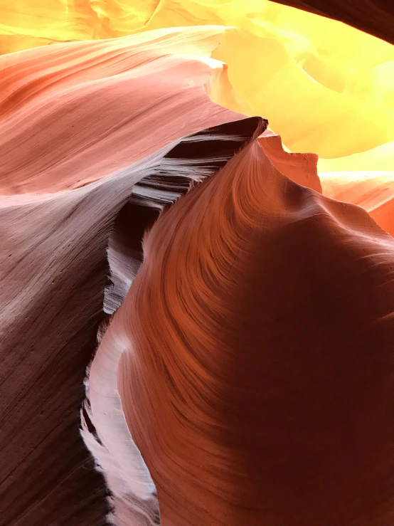 a large, narrow room of sand with a yellow and red light