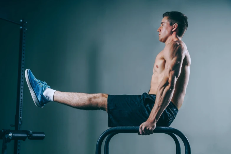 a man in blue shorts sitting on a machine