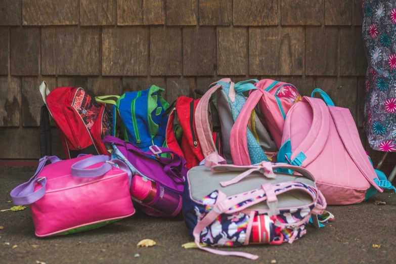 colorful bags piled on the ground, lined up