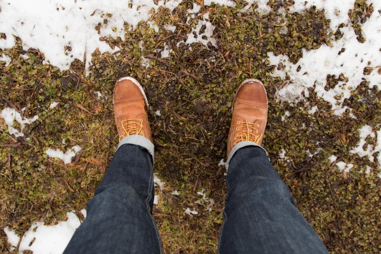 the legs of a man standing in the snow