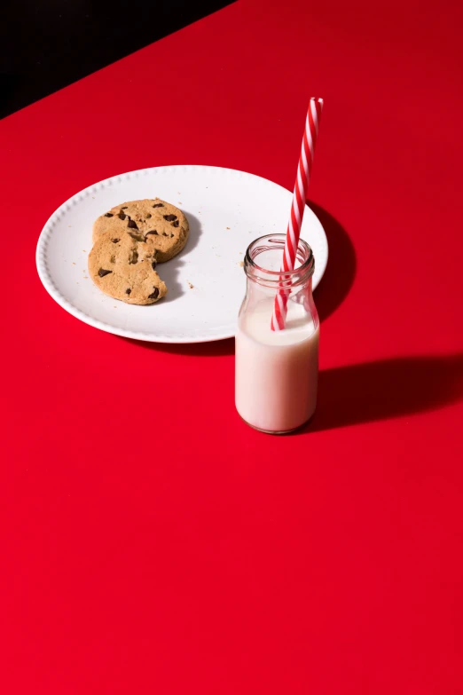 chocolate chip cookies next to milk on a plate