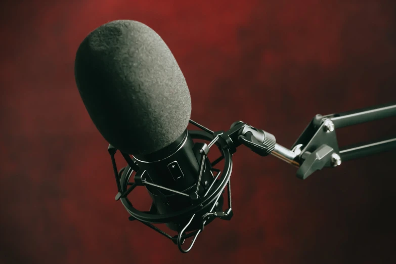 a microphone attached to a stand with red background